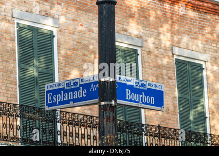 A street sign at the corner of Bourbon St. and Esplanade Ave. against a brick wall in the French Quarter of New Orleans, LA Stock Photo