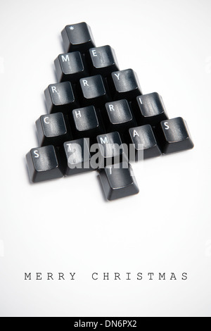 Christmas card - Christmas tree made of computer keys, white background with vignette Stock Photo