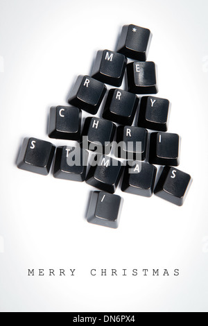 Christmas card - Christmas tree made of computer keys, white background with vignette Stock Photo
