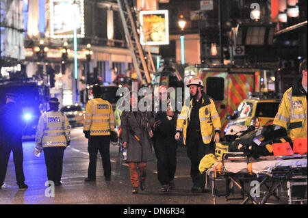 Shaftsbury Avenue, London, UK. 19th December 2013. People walk away from the Apollo Theatre collapse. At least 80 people were injured in the incident. Credit:  Matthew Chattle/Alamy Live News Stock Photo