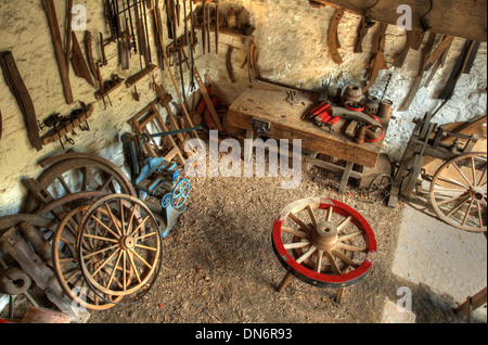 Traditional wheelwrights workshop with tools and cartwheels, England. Stock Photo