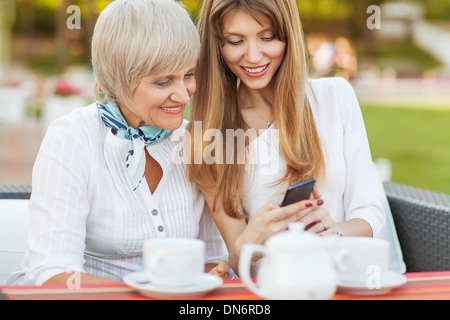 adult mother and daughter siting in cafe Stock Photo