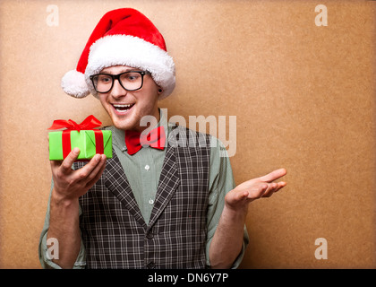 bright picture of handsome man in christmas hat. Stock Photo