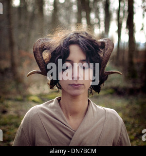 Woman with closed eyes and ram horns Stock Photo