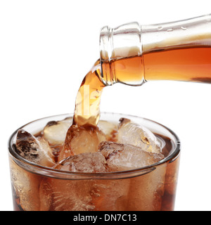 Cola is pouring from a bottle into a glass, isolated on white Stock Photo