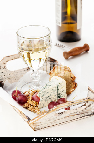 Snacks Dor Blue cheese, nuts, grapes and wine on tray Stock Photo