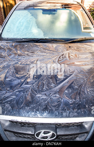 FROST AND ICE ON A CAR IN THE MORNING WITH EARLY MORNING SUN JUST REACHING IT Stock Photo