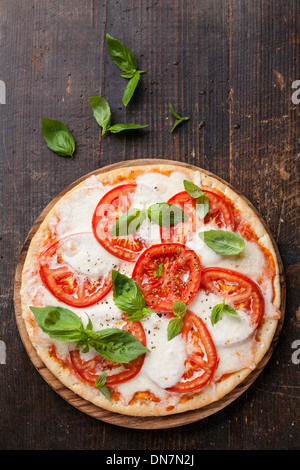 Pizza Caprese with mozzarella, tomatoes and basil leaves Stock Photo