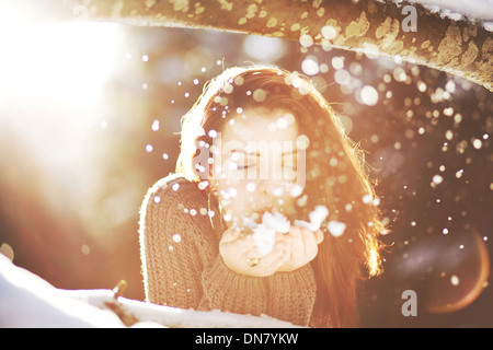 Portrait a young woman in snow in backlight Restrictions:This image has additional restrictions.Please contact us. Stock Photo