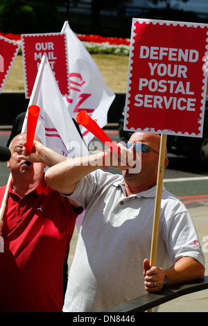 Postal workers and campaigners from the Communication Workers Union protest outside the Royal Mail headquarters Stock Photo