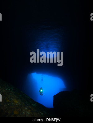 Scuba diver in a cave at Reqqa point in Gozo, Europe. Stock Photo