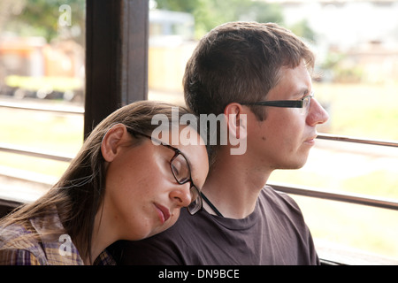 Young couple on a train in a carriage, woman sleeping, Trinidad, Cuba, Caribbean Stock Photo