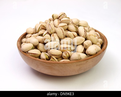 Bowl of pistachio nuts on a white background Stock Photo