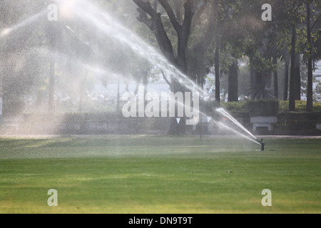 Lawn watering in Morning at Park. Stock Photo