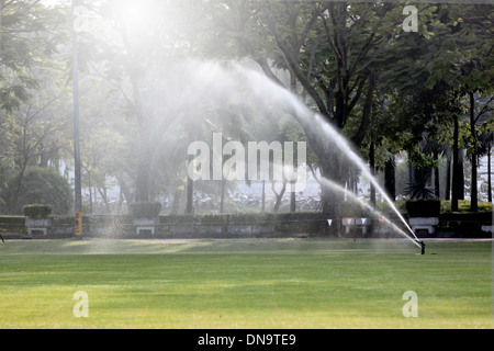 Lawn watering in Morning at Park. Stock Photo