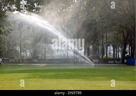 Lawn watering in Morning at Park. Stock Photo