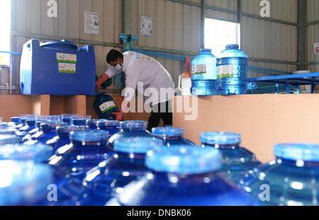 Phnam Penh, Cambodia. 11th Oct, 2013. Water bottles are filled in the project Teuk Saat / 1001 Fountaines in Preak Ta In village in Phnam Penh, Cambodia, 11 October 2013. A system is being built here to make water contaminated with arsenic drinkable again with the support of UNICEF. Cambodia is one of the top 20 worst countries for child malnutrition. There are 670,000 orphans and every 22nd child dies in its first year. Photo: Jens Kalaene/dpa/Alamy Live News Stock Photo