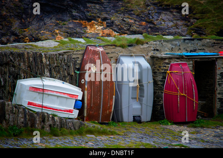 Dinghies tied up on the harbour wall, Boscastle, Cornwall, England Stock Photo