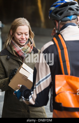 Young Woman Receiving A Package Stock Photo