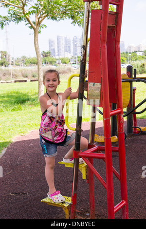 Little girl on street exercise machines Stock Photo