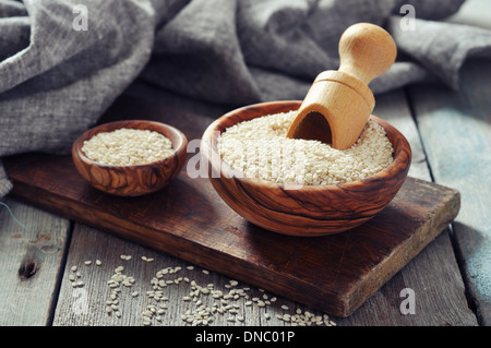 Sesame seeds in wooden bowl on wooden background Stock Photo