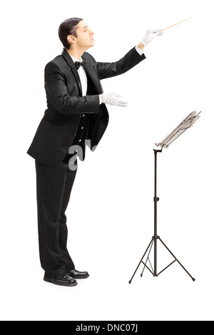 Full length portrait of a male orchestra conductor directing with stick Stock Photo