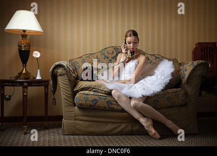 Professional ballet dancer talking on the phone in luxury interior Stock Photo