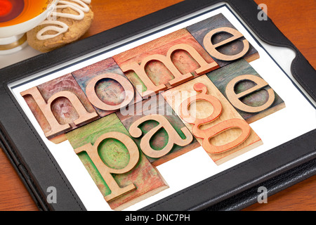 home page - text in letterpress wood type on a digital tablet with cup of tea Stock Photo