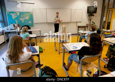 Teacher in classroom is talking to students Stock Photo