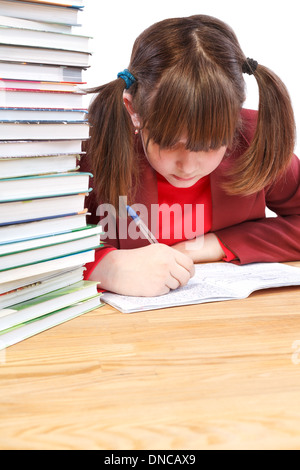 Schoolgirl makes written exercises in school notebooks Stock Photo
