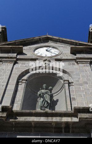 A clock and saint statue in the center of the facade of St Louis Cathedral, Port Louis, Mauritius. Stock Photo