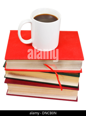 white mug of coffee on stack of books isolated on white background Stock Photo