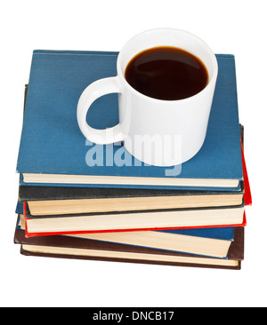 above view mug of coffee on stack of books isolated on white background Stock Photo