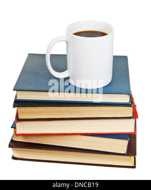 white cup of coffee on stack of books isolated on white background Stock Photo