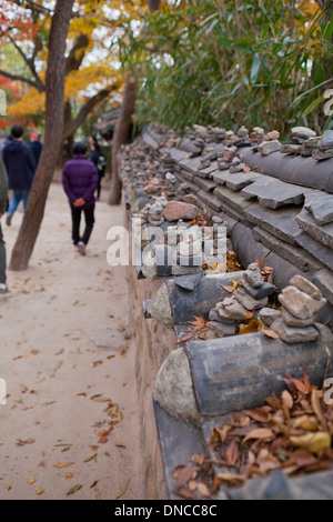 Giwa (fired clay roof tiles) used on  traditional Hanok style stone wall fence - Gyeongju, South Korea Stock Photo