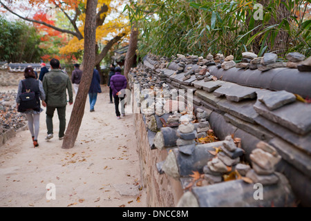 Giwa (fired clay roof tiles) used on  traditional Hanok style stone wall fence - Gyeongju, South Korea Stock Photo