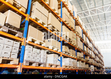 Rows of shelves with boxes in modern warehouse Stock Photo