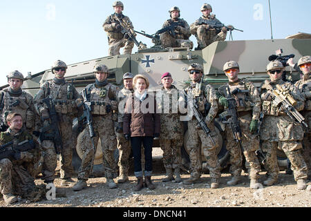 Mazar-e Sharif, Afghanistan. 23rd Dec, 2013. New German Defense Minister Ursula von der Leyen (C) poses for a photograph as she visits German troops at Camp Marmal in Mazar-e Sharif, Afghanistan, 23 December 2013. The visit has taken place as NATO and Afghan officials began drawing up plans on cooperation after troop withdrawal. Photo: MAURIZIO GAMBARINI/dpa/Alamy Live News Stock Photo