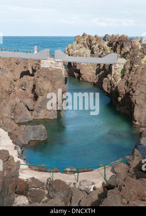 The natural swimming pools of Porto Moniz, Madiera provide shelter from the Atlantic ocean Stock Photo