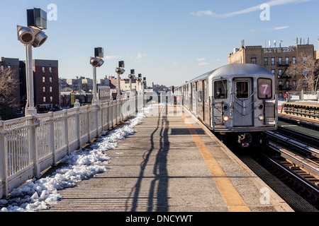 Number seven local train to Flushing arrives at station in Queens, New York. Stock Photo