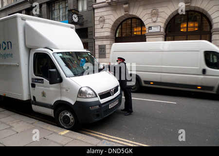 Parking warden placing a parking ticket on a white van in Cornhill City of London UK KATHY DEWITT Stock Photo