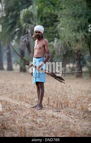 Man going to hunt with bow and arrow. Bhil tribe, Zabua district, Madhya Pradesh, India. Stock Photo
