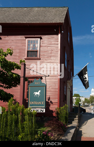 A man walks past The White Horse Tavern, one of Americas oldest taverns in Newport Rhode Island a New England tourist town. Stock Photo