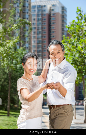 Cheerful mature couple dancing outdoors Stock Photo