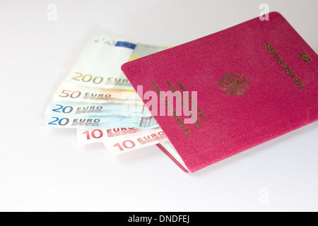 Several Euro-Notes lying in a german passport for traveling Stock Photo
