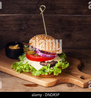 Burger with meat and greens wooden background Stock Photo