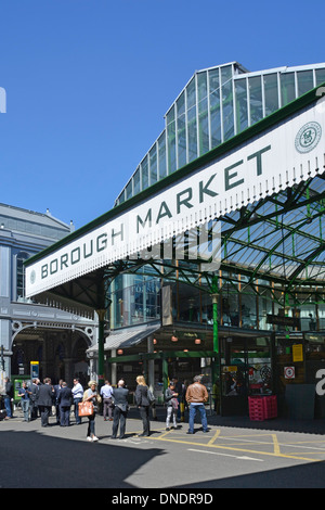 People outside famous historical Borough Market sign and entrance sells mainly speciality foods to the general public Southwark London England UK Stock Photo