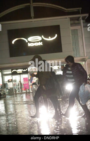 Merthyr Tydfil, Wales, UK. 23rd December 2013. Heavy rain continues unabated in South Wales and last minute shoppers have to negotiate huge puddles at a retail park in the Valley Town of Merthyr Tydfil. Credit:  Graham M. Lawrenc/Alamy Live News. Stock Photo