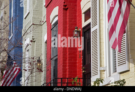 Washington, DC - Row houses painted red, white, and blue with American flags on Capitol Hill. Stock Photo