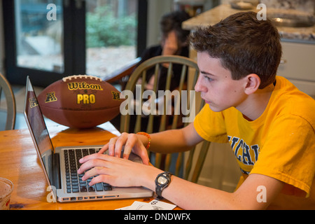 Washington, DC - High school freshman Joey West, 15, works on his laptop computer. Stock Photo